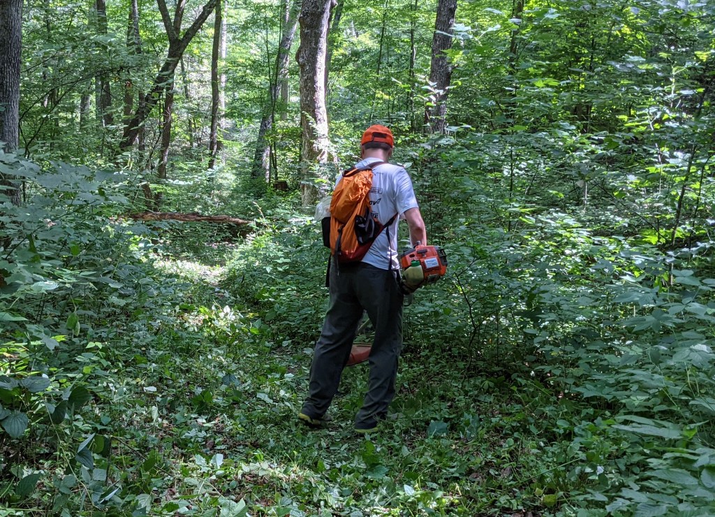 Cutting weeds on the Grindstone course. 