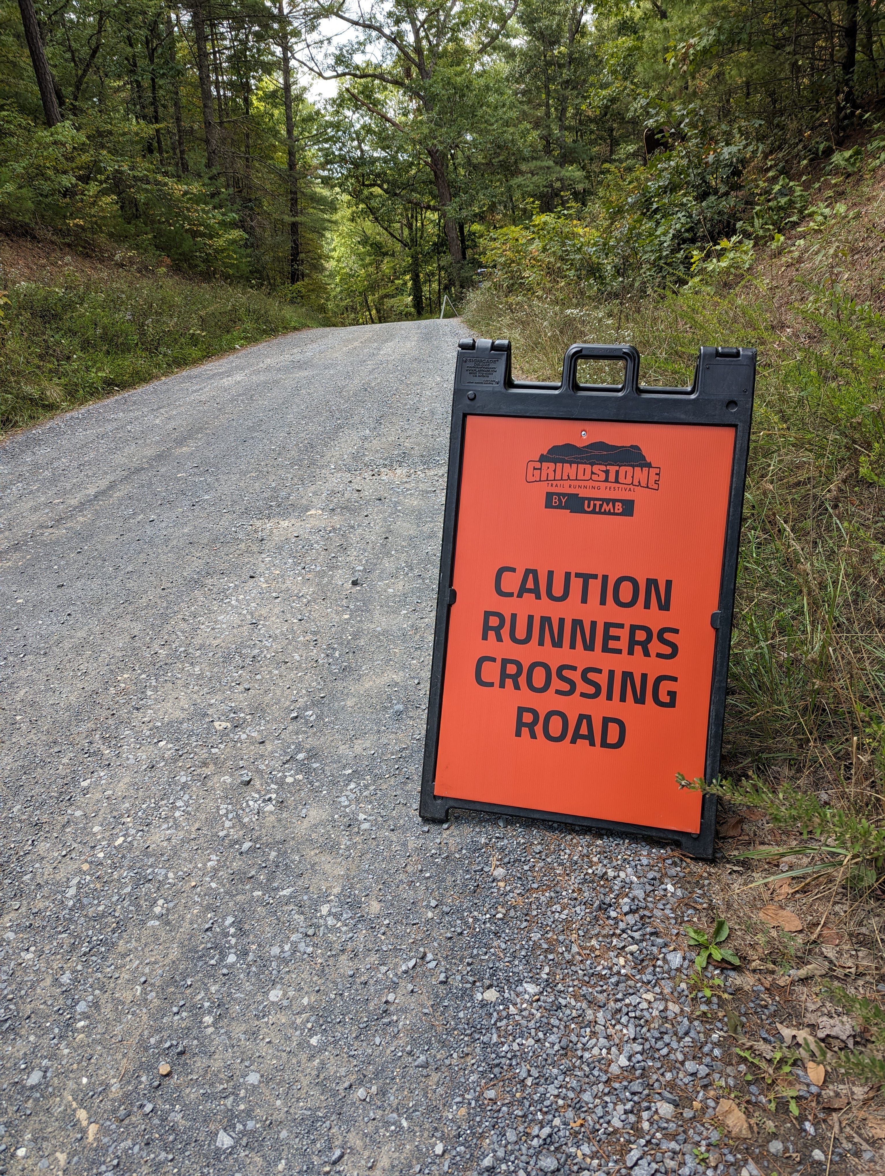 Sign cautioning traffic that runners are crossing the road. One of many similar signs on the grindstone course. 